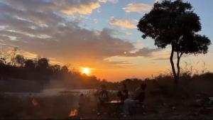 a group of people sitting around a table at sunset at Ideal for your vacation! in Buôn Dhă Prŏng