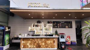 a coffee shop with a counter in a building at TTC Hotel Michelia in Nha Trang
