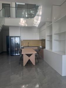 a kitchen with a wooden table and a counter at Ideal for your vacation! in Buôn Dhă Prŏng