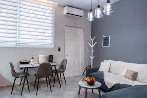 a living room with a blue couch and a table at Linea Nest Studio Near the Beach in Pissidhón +22 photos