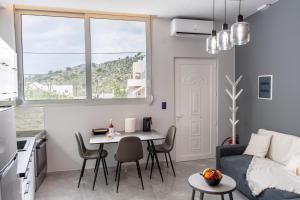 a living room with a table and a couch at Linea Nest Studio Near the Beach in Pissidhón