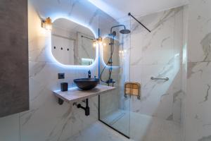 a bathroom with a sink and a mirror at Linea Nest Studio Near the Beach in Pissidhón