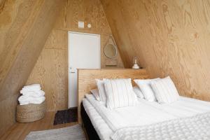 a bedroom with two beds with wooden walls at Lidö Värdshus in Lidö +67 photos