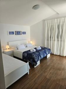a hotel room with two beds and a window at Villa Falcon in Podaca +98 photos