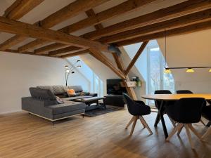 a living room with a couch and a table at Schloss Espasingen Apartment 4 in Stockach