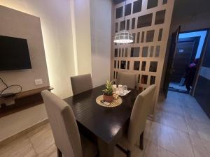 a dining room with a black table and chairs at Mahadev Hotel in Zirakpur
