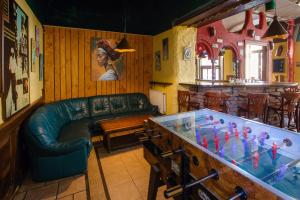 a living room with a couch and a table with a chess at Cuba Bar & Hostel in České Budějovice