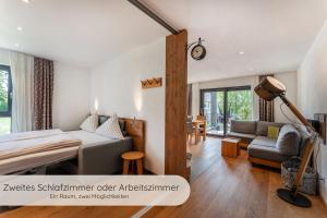 a bedroom with a bed and a couch at INVITA Natur-Chalets - Familienurlaub im Schwarzwald in Bad Dürrheim