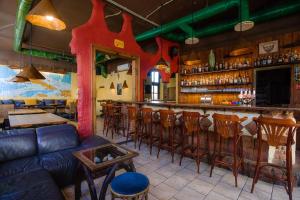 a restaurant with a bar with wooden stools at Cuba Bar & Hostel in České Budějovice