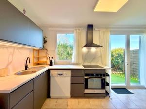 a kitchen with a sink and a stove at La salamandre bleue : 4 pers piscine à Calvisson in Calvisson