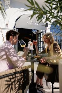 a man and a woman sitting at a table at Jadran Heritage Hotel, Valamar Collection in Poreč