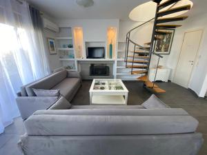 a living room with a couch and a table at Nautica Villa in Hanioti