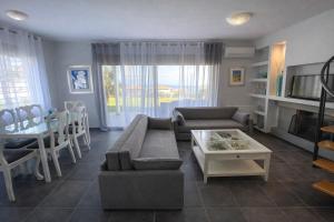 a living room with a couch and a table at Nautica Villa in Hanioti