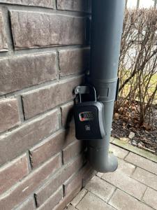 a clock on the side of a brick wall at Art Academy Apartment in Tallinn