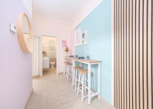 a kitchen with a bar and stools in a room at Luxury Vatican Home - Private Garden in Rome