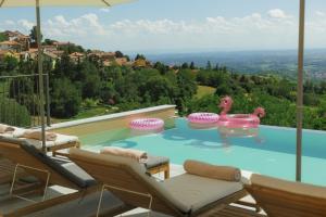 a swimming pool with a person in a inflatable at Alle tre Colline in Albugnano 
