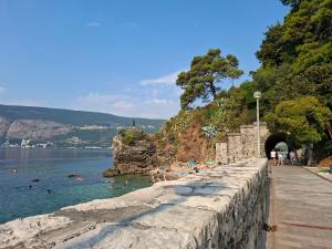 a group of people in the water at a beach at Top Topla - Herceg Novi in Topla