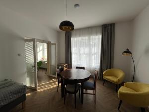 a living room with a table and chairs and a room at Apartmán Na Valešince in Příbram +12 photos
