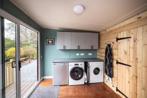a laundry room with a washer and dryer at The Old Coach House in Pitlochry