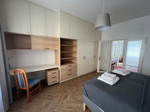 a bedroom with a bed and a desk and a chair at Apartmán Na Valešince in Příbram