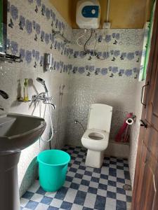 a small bathroom with a toilet and a sink at Soshing Homestay in Ravangla