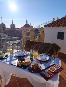 a table with food and wine on a balcony at El Palacete de Cuevas in Cuevas del Almanzora