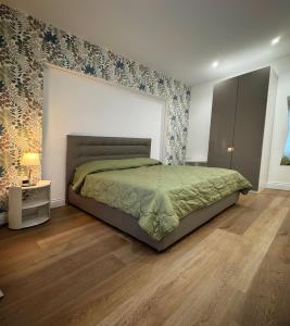 a bedroom with a large bed and a wooden floor at Maison Trentasette in Potenza
