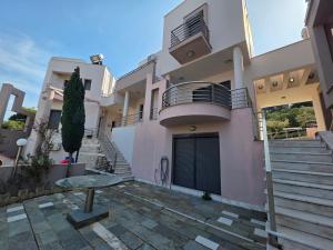 a house with stairs and a table in front of it at Venetia Luxurious Villa in Iraklitsa