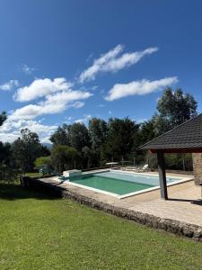 a swimming pool in the middle of a yard at Cabaña julian in Villa Berna +2 photos