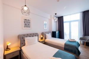 a hotel room with two beds and a window at Stil Old Town Boutique Hotel in Bucharest