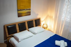 a bedroom with a large bed with a blue blanket at The Hidden Cellar by Heavens Hall in Alexandroupoli