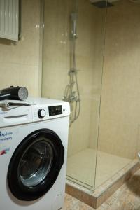 a washing machine in a bathroom with a glass wall at The Hidden Cellar by Heavens Hall in Alexandroupoli +10 photos