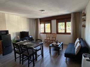 a living room with a table and a couch at Rubín 21 in Redondela