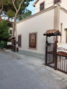 a gate in front of a white building with a window at Affittacamere Rosy in Foligno +32 photos