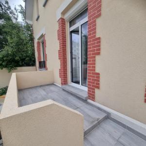 a bench sitting on the outside of a building at Résidences Eska in Bobigny