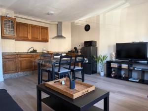 a kitchen with wooden cabinets and a table with chairs at Rubín 21 in Redondela