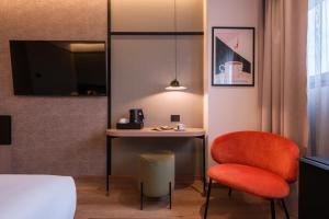a room with a bed and a desk and a chair at Savhotel Mantegna Padova in Padova +56 photos