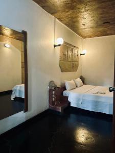 a hotel room with a bed and a mirror at Hotel Sokhamon in Dakar