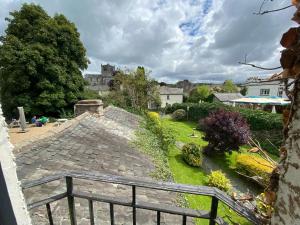 a view of a garden with a castle in the background at The Cavendish Arms in Cartmel