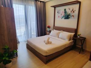 a bedroom with a bed with a box on it at Timurbay Seafront By Ocean waves in Kuantan +20 photos