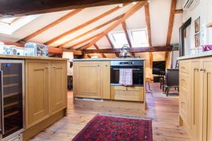 a kitchen with wooden cabinets and an oven at Tolmin center apartments Townhouse & Loft in Tolmin