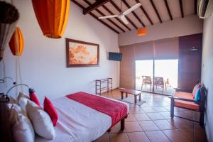 a bedroom with a bed and a table and chairs at The Beach Cabanas Retreat & Spa in Koggala