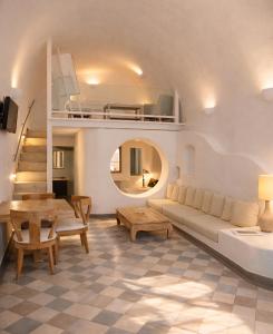 a living room with a couch and a table at Ikastikies Suites in Firostefani +95 photos