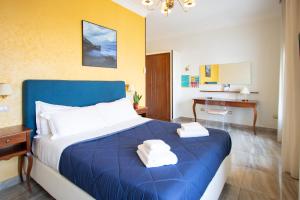 a bedroom with a blue bed and a desk at NeapolitanTrips Hotel in Naples +27 photos
