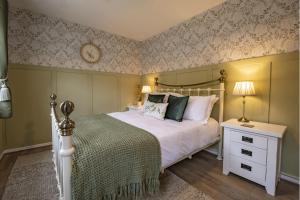 a bedroom with a bed and a clock on the wall at Boar Edge Cottage in Richmond