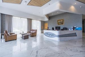 an office lobby with a reception desk and chairs at Hotel Franca Tivat in Tivat