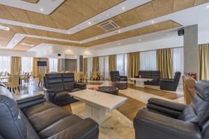 a lobby with leather furniture and tables and chairs at Hotel Franca Tivat in Tivat +39 photos
