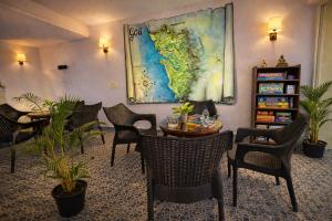 a room with chairs and a table and a map on the wall at Praia Da Oura Boutique Resort ,Goa in Majorda