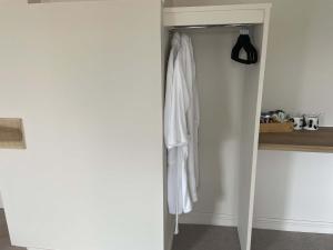 a white robe hanging on a door in a room at Stillington Retreat in Stillington +7 photos