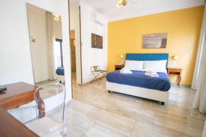 a bedroom with a bed and a room with a table at NeapolitanTrips Hotel in Naples